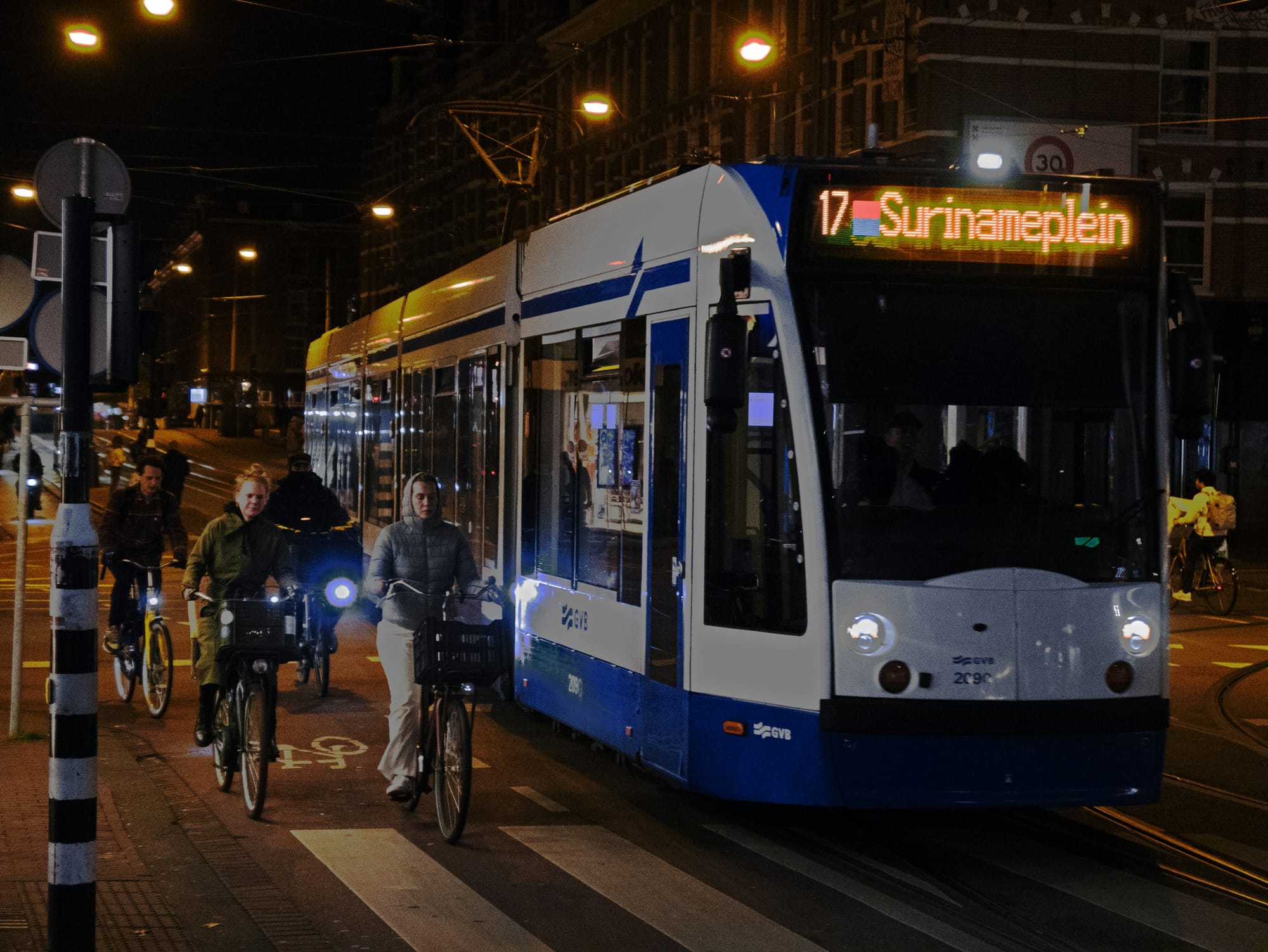 A photo of a street being safely shared by cyclists and a tram (streetcar).