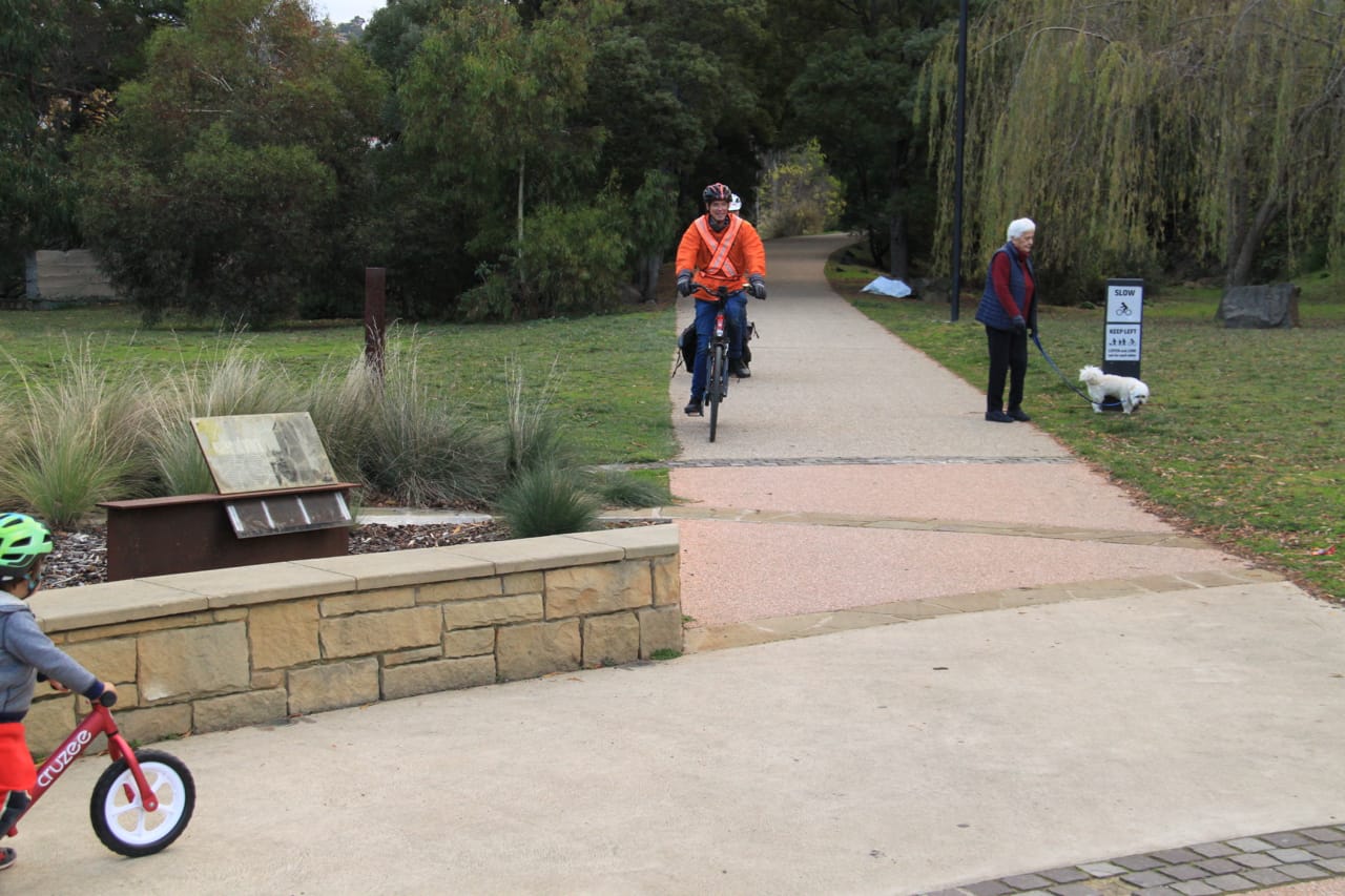 Photo of cyclists and a pedestrian walking a dog enjoying use of the South Hobart rivulet pathway.